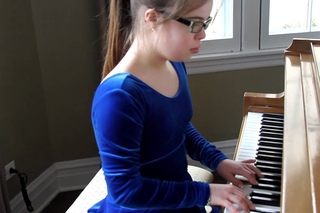 Lauren Miller Playing the Piano - Lauren has Down Syndrome